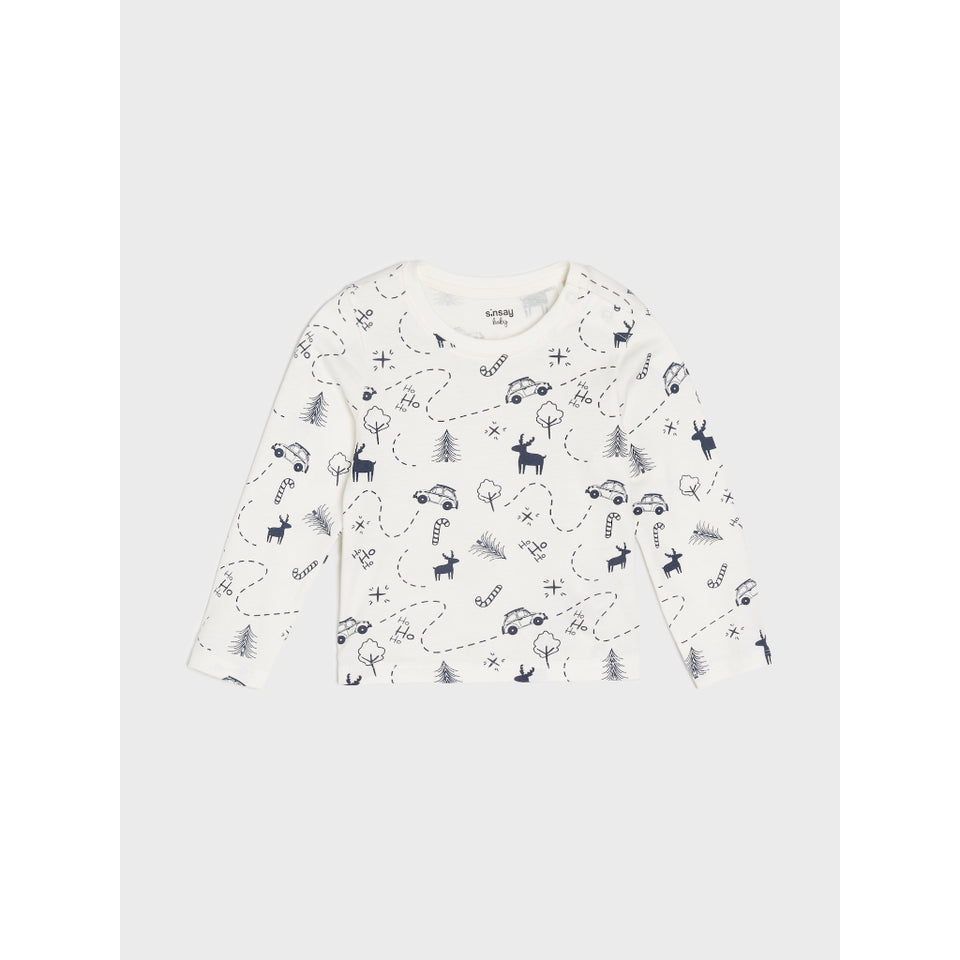 A long-sleeve baby t-shirt in off-white with a navy blue winter-themed print featuring reindeer, snowmobiles, and trees, displayed flat against a light gray background.