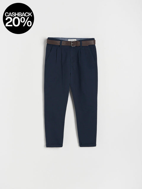 Navy blue pants with a brown belt on a light gray background