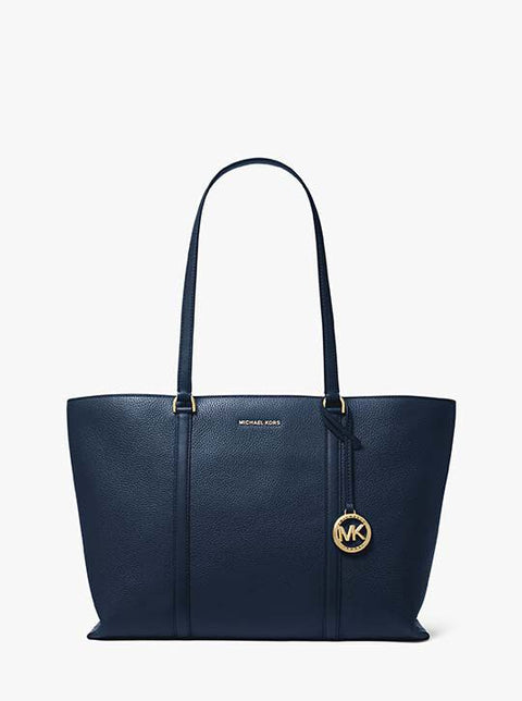Navy blue handbag with gold logo on a white background