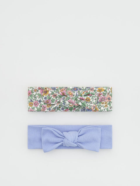 Floral headband and light blue bow on a white background