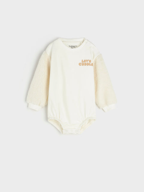 White baby onesie with text on a white background