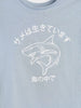 Light blue t-shirt with a white shark graphic and Japanese text on a light blue background