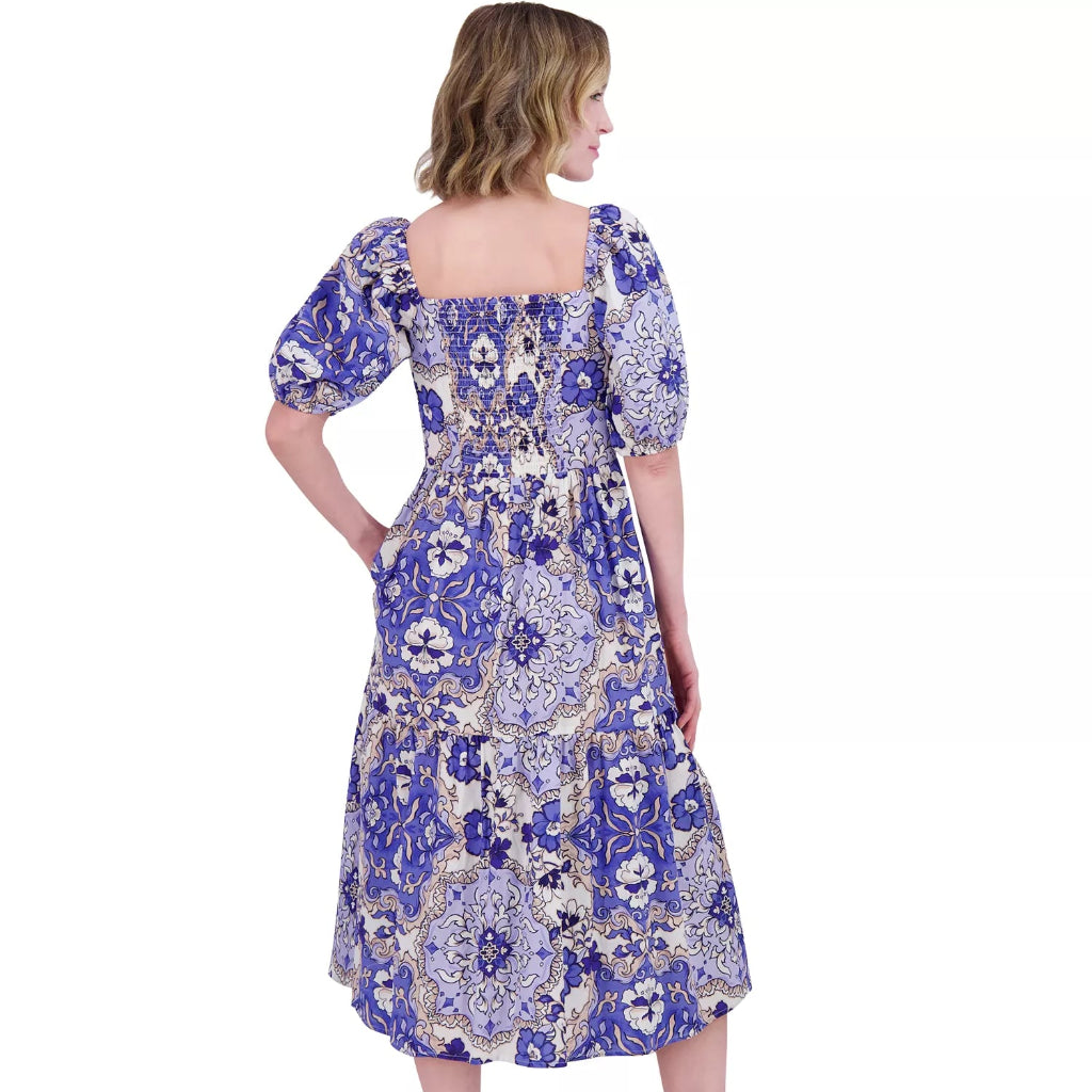 Woman wearing a blue floral dress on a white background