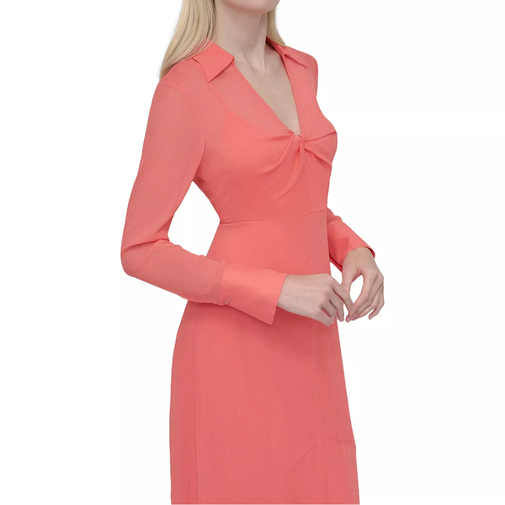 Woman wearing a coral dress on a white background