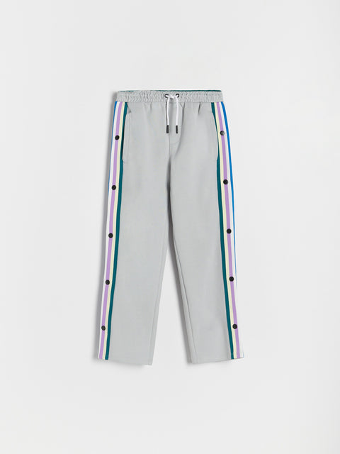 Light gray pants with colorful stripes on a white background