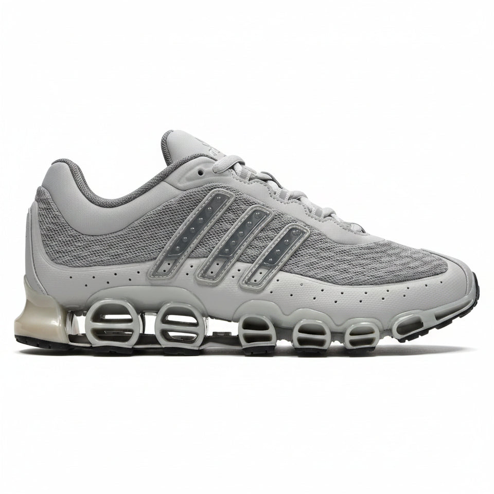Gray athletic shoe with unique sole design on a white background
