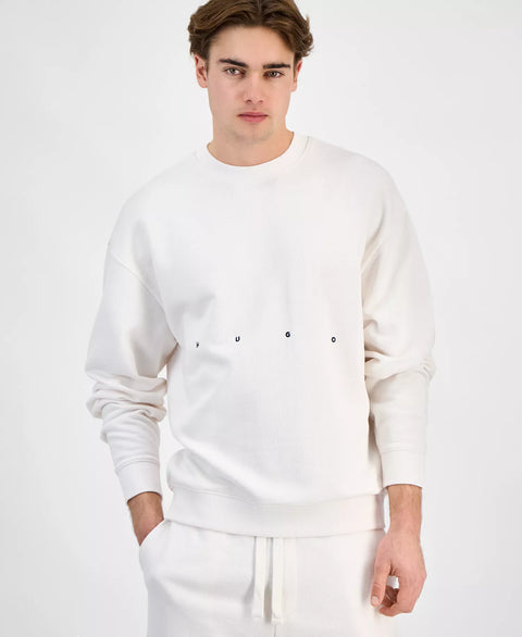 Man wearing a white sweatshirt and pants on a plain background