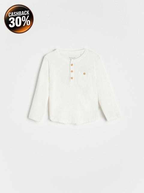 White long-sleeve shirt with buttons on a light gray background