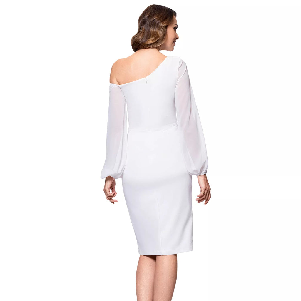 A woman shown from the back wearing a white one-shoulder midi dress with sheer long sleeves and a fitted silhouette, paired with white high-heeled sandals on a plain white background.