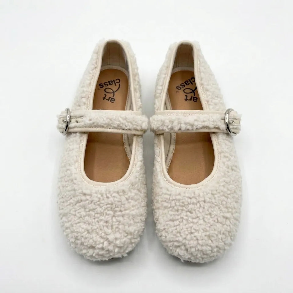 A pair of cream-colored, textured boucle Mary Jane shoes with silver-tone buckle straps, displayed on a clean white background.