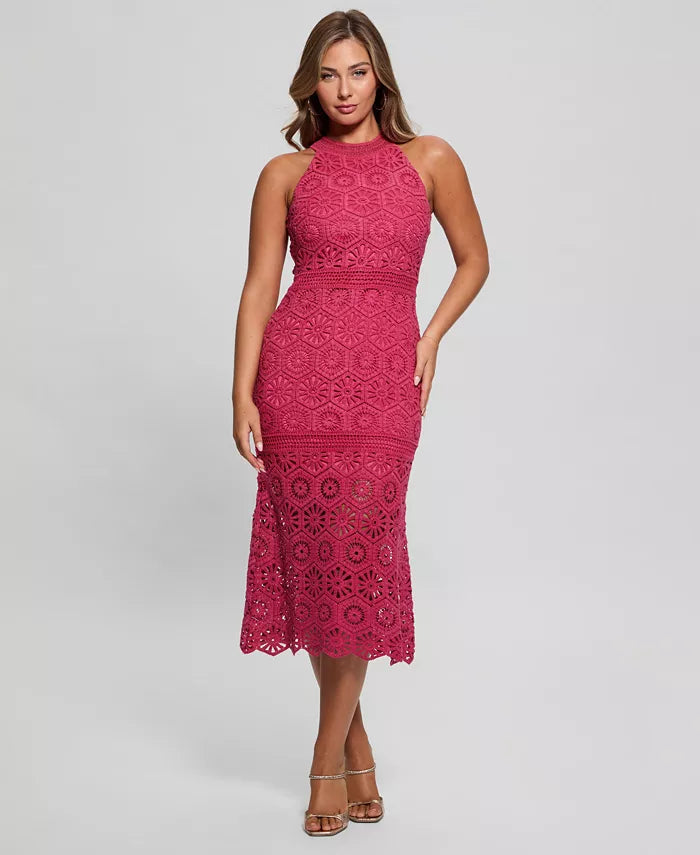 Woman wearing a pink lace dress on a gray background