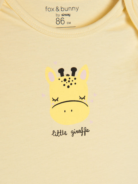 Yellow baby shirt with a giraffe design and 'fox & bunny' branding.