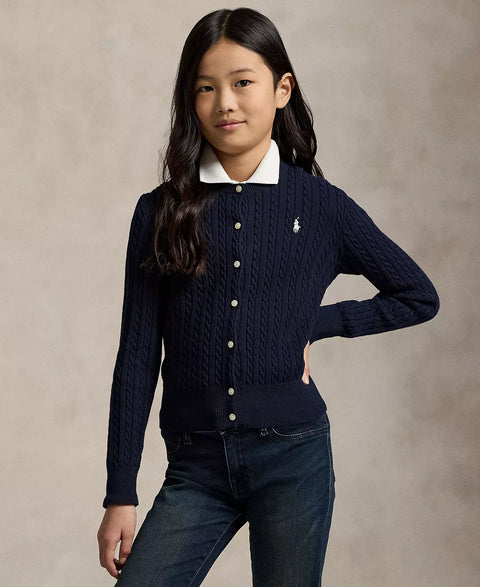 Young girl wearing a navy sweater with a white collar and Ralph Lauren logo on a beige background