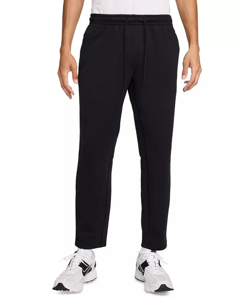 Black pants worn by a person on a white background