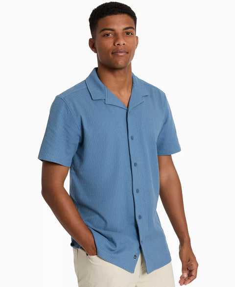 Man wearing a blue short-sleeve shirt on a white background