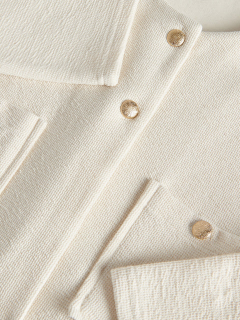 Close-up of a cream-colored fabric with buttons