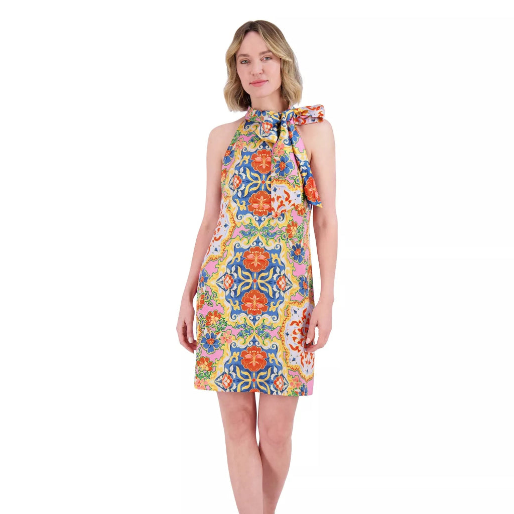 Woman wearing a colorful floral dress on a white background
