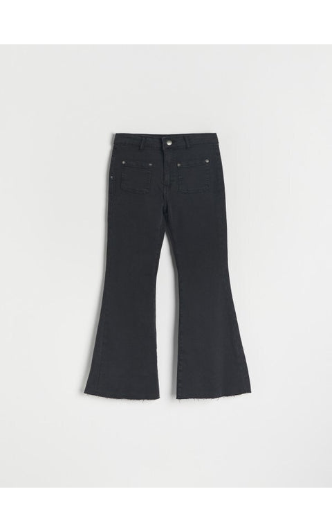 Black flared jeans on a white background