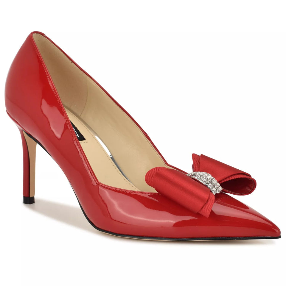 A red patent leather pump with a satin bow and crystal-embellished detail on the toe, shown against a plain white background.