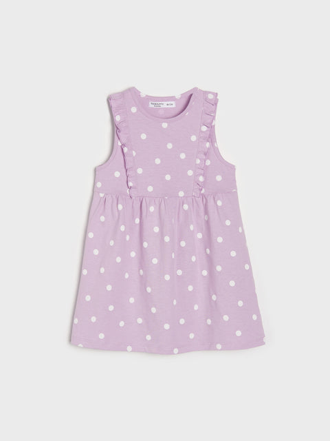 Purple dress with white polka dots on a light gray background