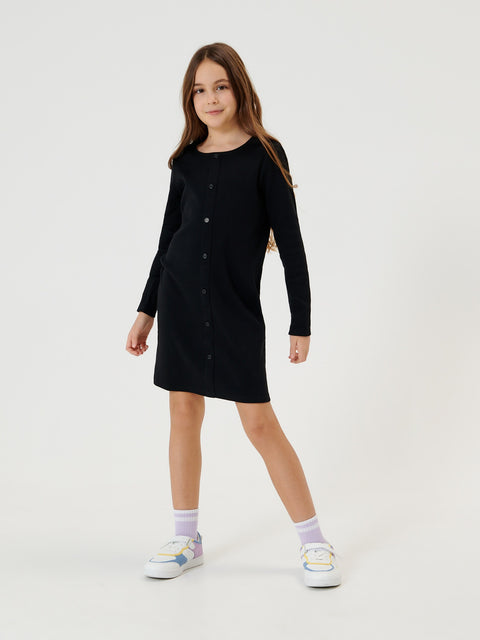 Young girl wearing a black dress on a white background