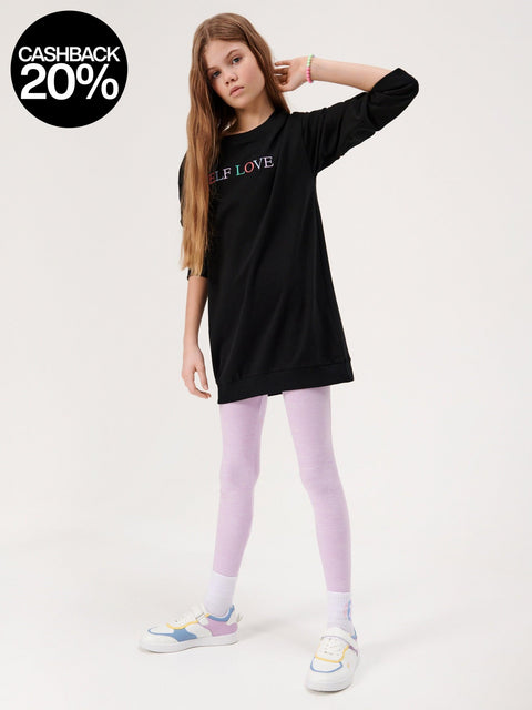 Person wearing a black hoodie with 'SELF LOVE' text, purple leggings, and colorful shoes on a white background