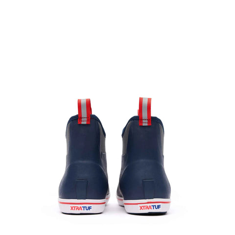 Navy rain boots with red and white straps on a white background