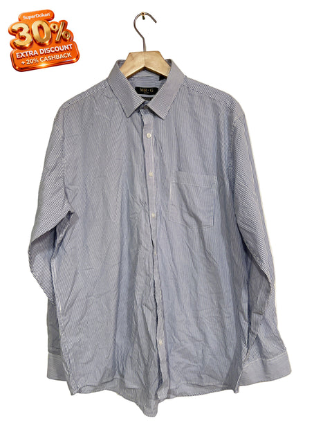 Unfolded blue shirt on a beige background