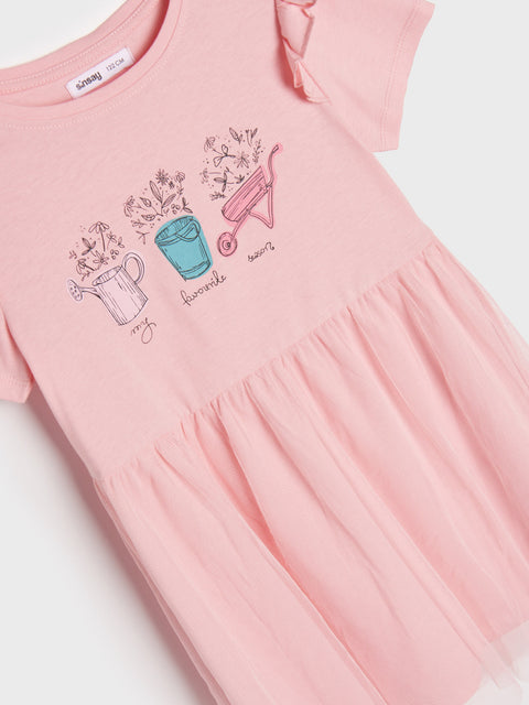 Pink dress with gardening-themed embroidery on a white background