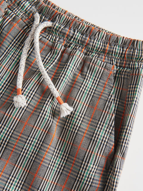Plaid shorts with a drawstring on a light gray background