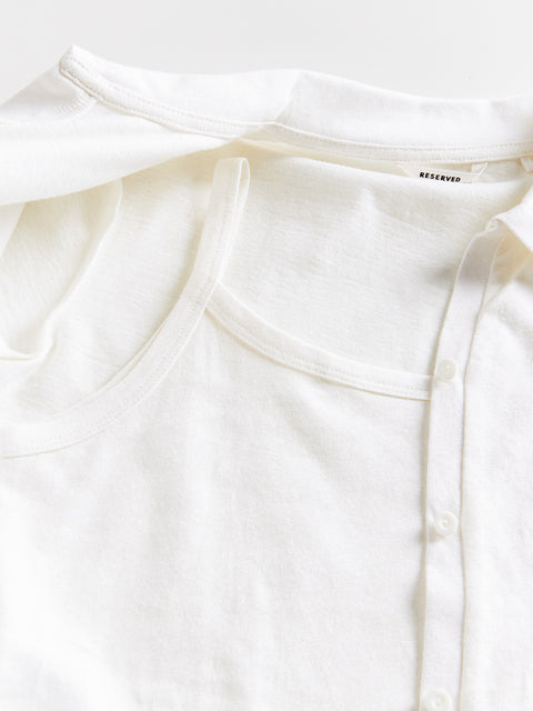 White blouse with a brand label on a white background