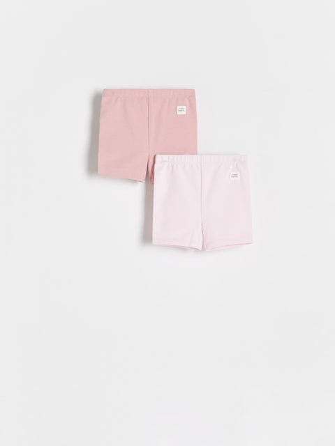 Two pink pairs of underwear on a white background