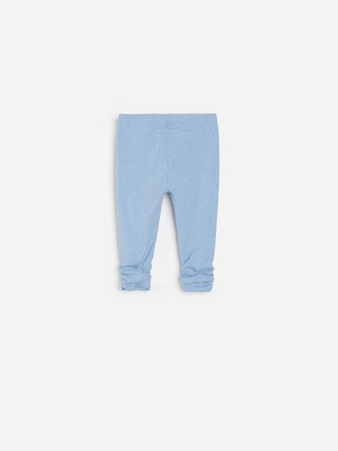 Light blue baby leggings on a white background