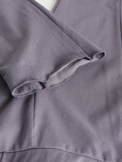 Close-up of a textured gray fabric with a visible seam.