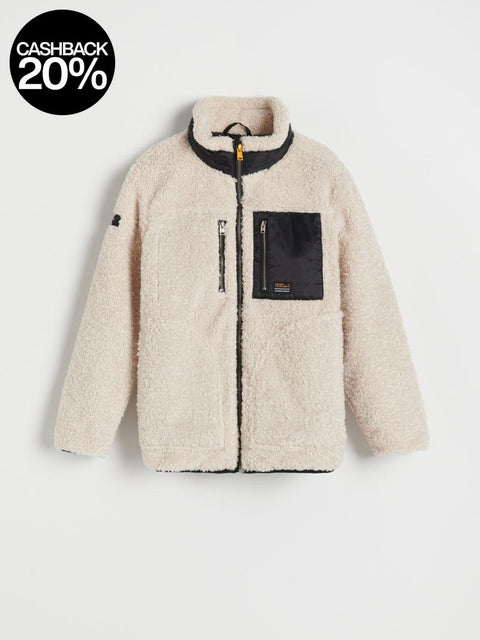 Beige fleece jacket with black accents on a light gray background, featuring a cashback 20% offer.