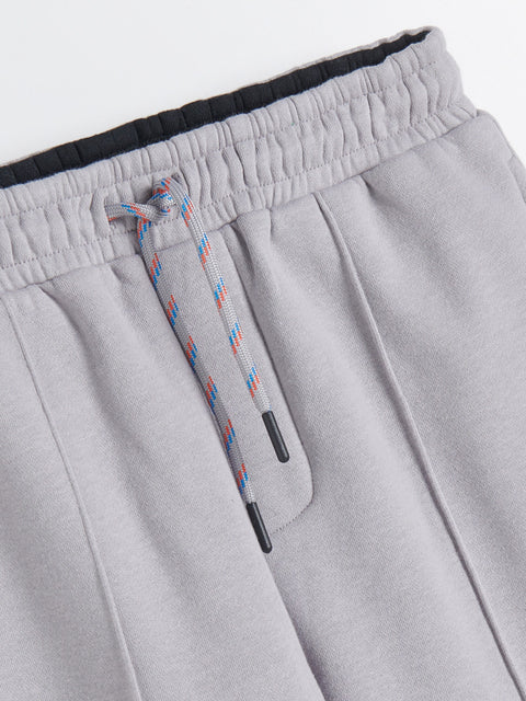 Gray sweatpants with a drawstring on a light gray background