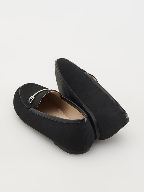 Pair of black loafers on a light gray background