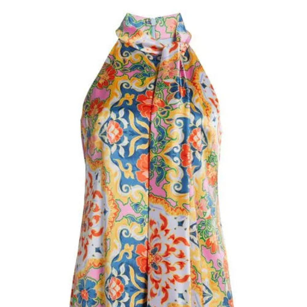 A sleeveless halter-neck dress featuring a vibrant, multicolored baroque-style floral and scroll pattern on a light background.