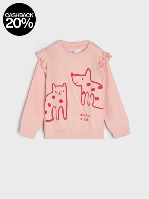 Pink sweater with red cat and dog graphics on a light gray background