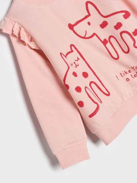 Pink sweatshirt with red cat illustrations and text on a light gray background