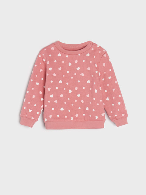 Pink sweatshirt with white heart patterns on a light gray background