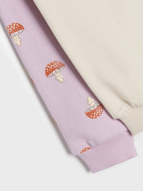 Light purple pants with mushroom and bear design on a white background