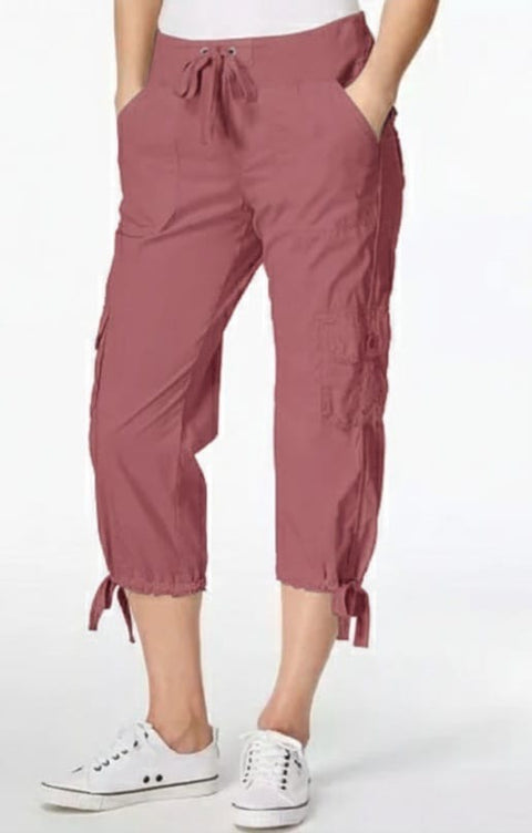Person wearing maroon cargo pants with a white background