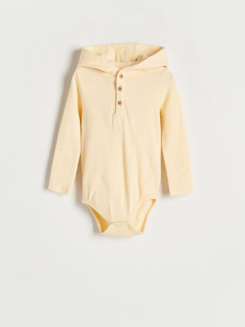 Yellow baby bodysuit with long sleeves on a light gray background
