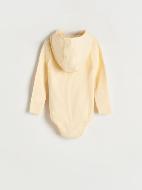 Yellow baby bib on a light gray background