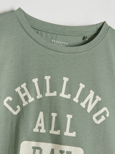 Green t-shirt with 'CHILLING ALL DAY' text on a plain background