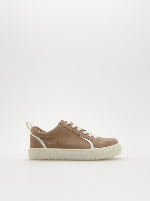Brown sneaker with white sole on a light gray background