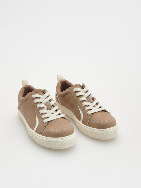 Pair of brown sneakers with white laces on a light gray background