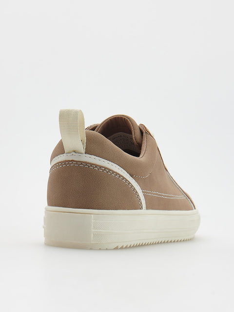 Brown sneaker with white sole on a light gray background