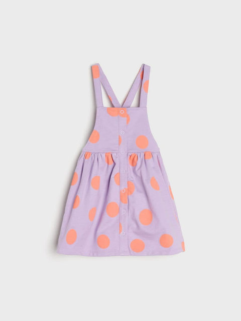 Purple dress with orange polka dots on a light purple background